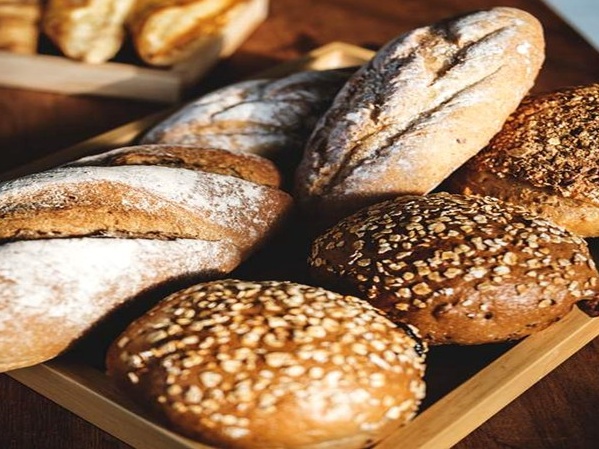 A selection of freshly baked artisan breads and golden pastries from a master baking masterclass at The Old Inn.