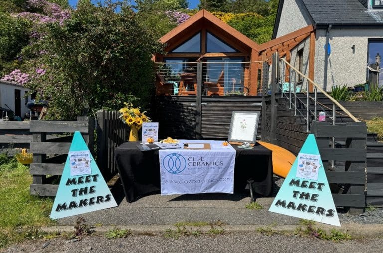 Artistic hand-thrown pottery pieces and botanical illustrations on display in a local Gairloch studio.