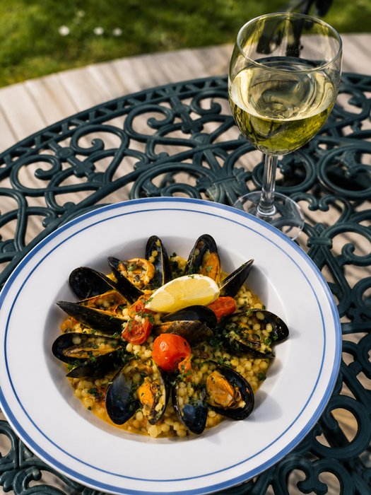 Seafood fregola served in the beautiful outdoor area of The Old Inn
